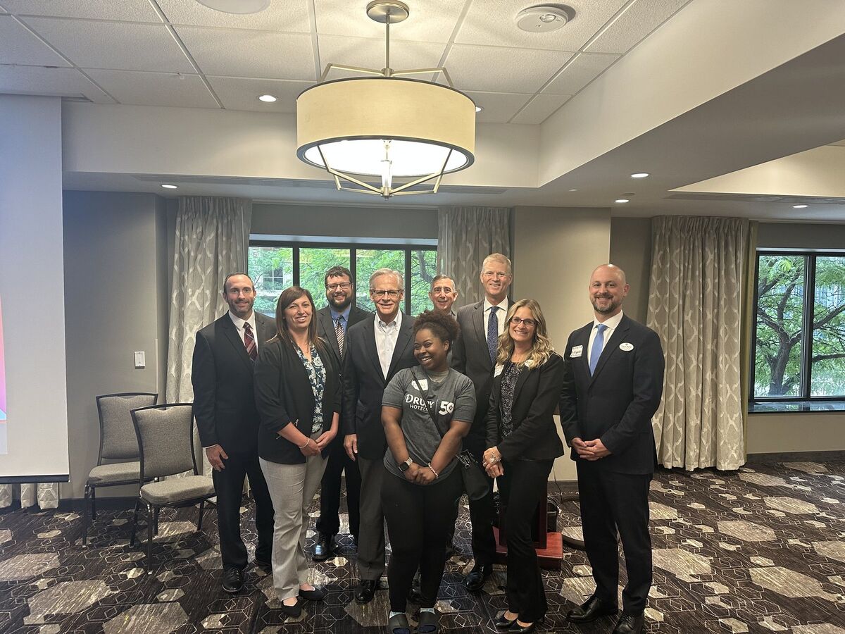 Kay Kay connecting with local professionals at a community gathering