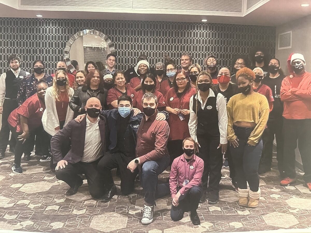 A large group of community members posing together indoors