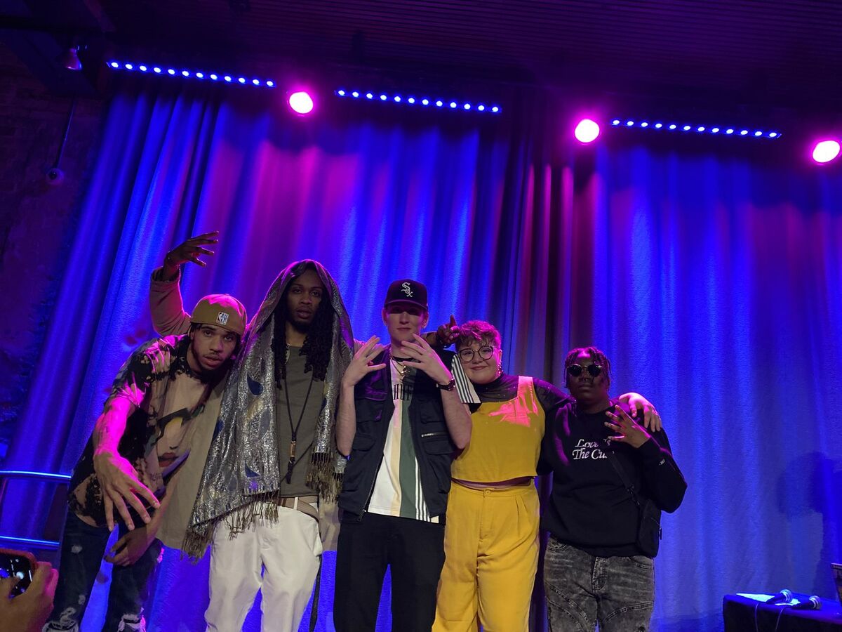 Community members standing together on a live event stage